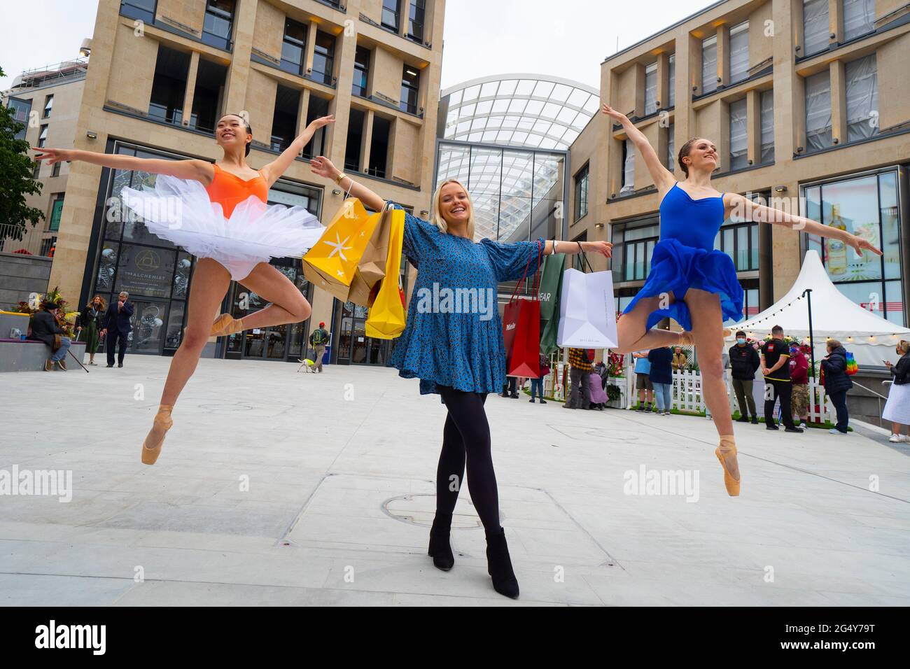 Edinburgh, Scotland, UK. 24 June 2021. First images of the new St James Quarter which opened this morning in Edinburgh. The large retail and residential complex replaced the St James Centre which occupied the site for many years. Pic; dancers perform outside at official opening. Iain Masterton/Alamy Live News Stock Photo