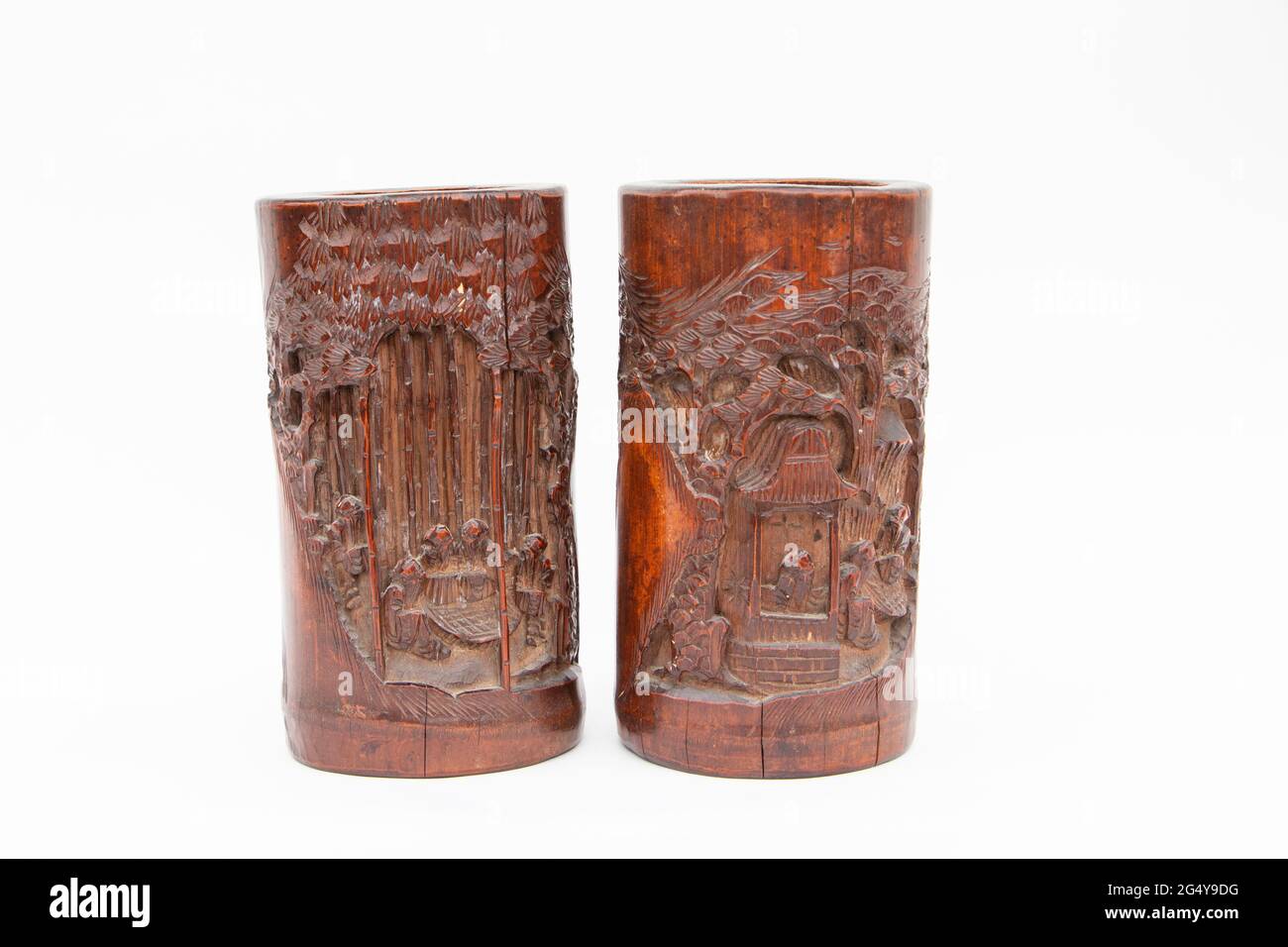 two vintage bamboo carved wooden brush holder pots on a white studio background Stock Photo Alamy