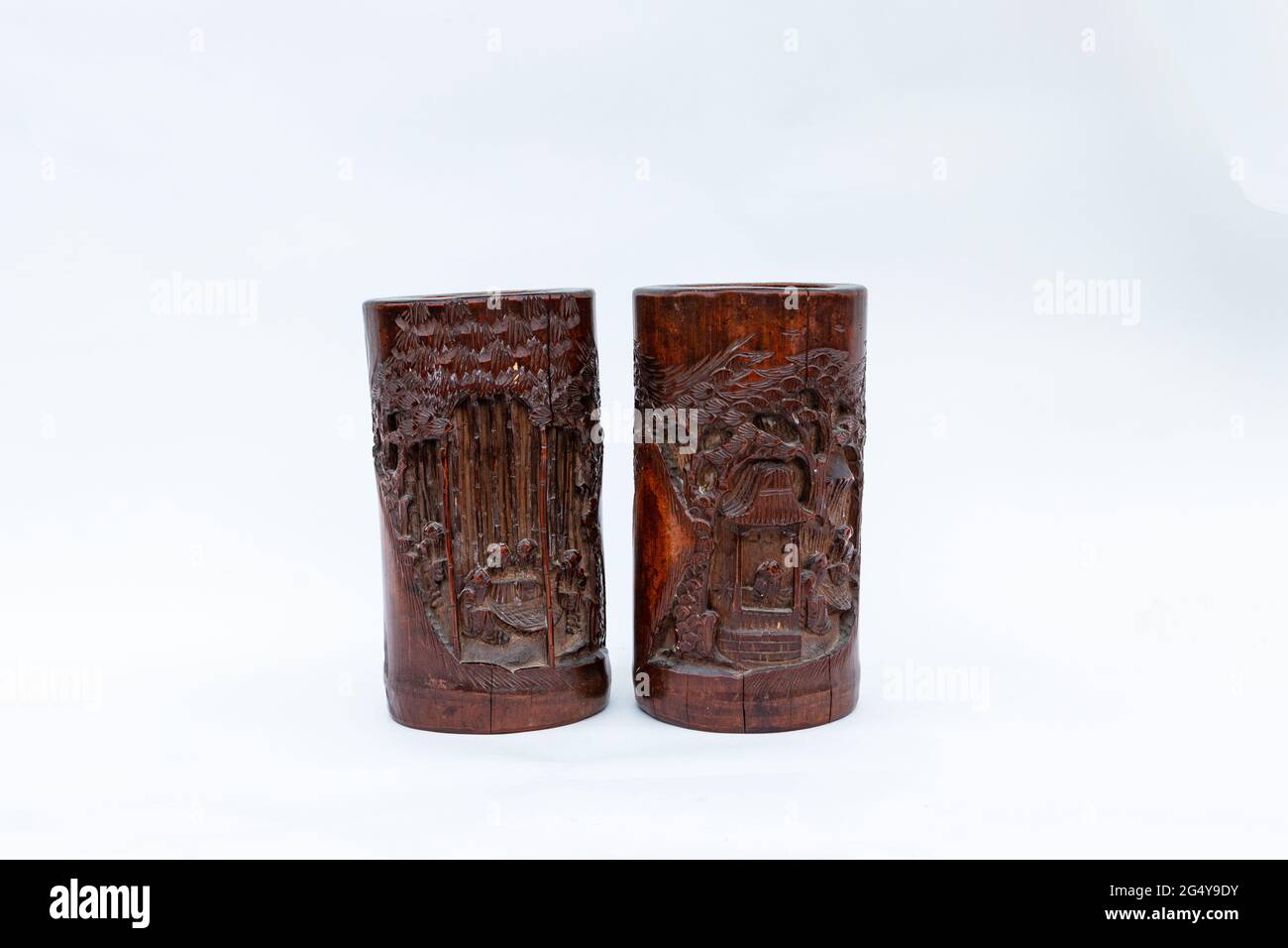 two vintage bamboo carved wooden brush holder pots on a white studio background Stock Photo Alamy