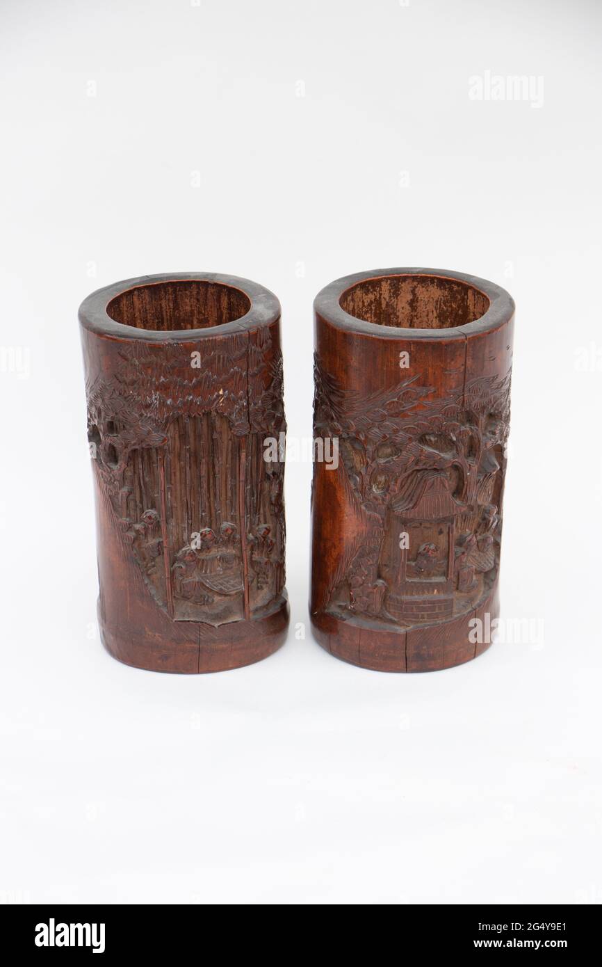 two vintage bamboo carved wooden brush holder pots on a white studio background Stock Photo Alamy