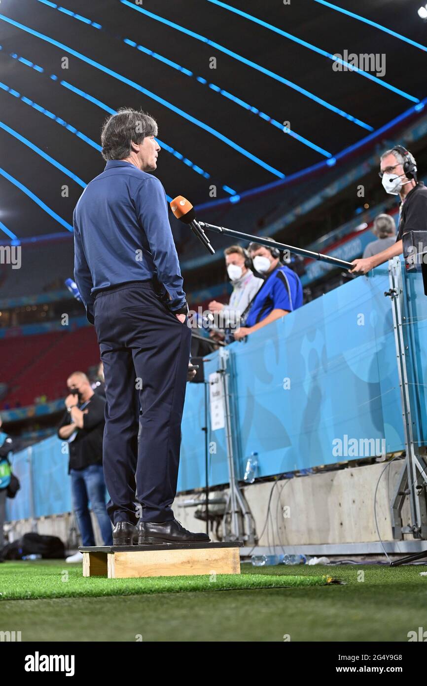Federal coach Joachim Jogi LOEW, LOW (GER), stands on a podium in front of  the ZDF microphone during the interview. Group stage, preliminary round  group F, game M36, Germany (GER) - Hungary (