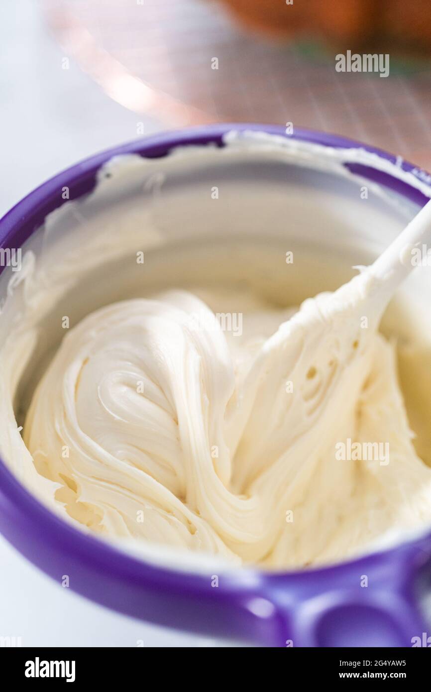 Melting storebought buttercream frosting in candy melting pot to glaze