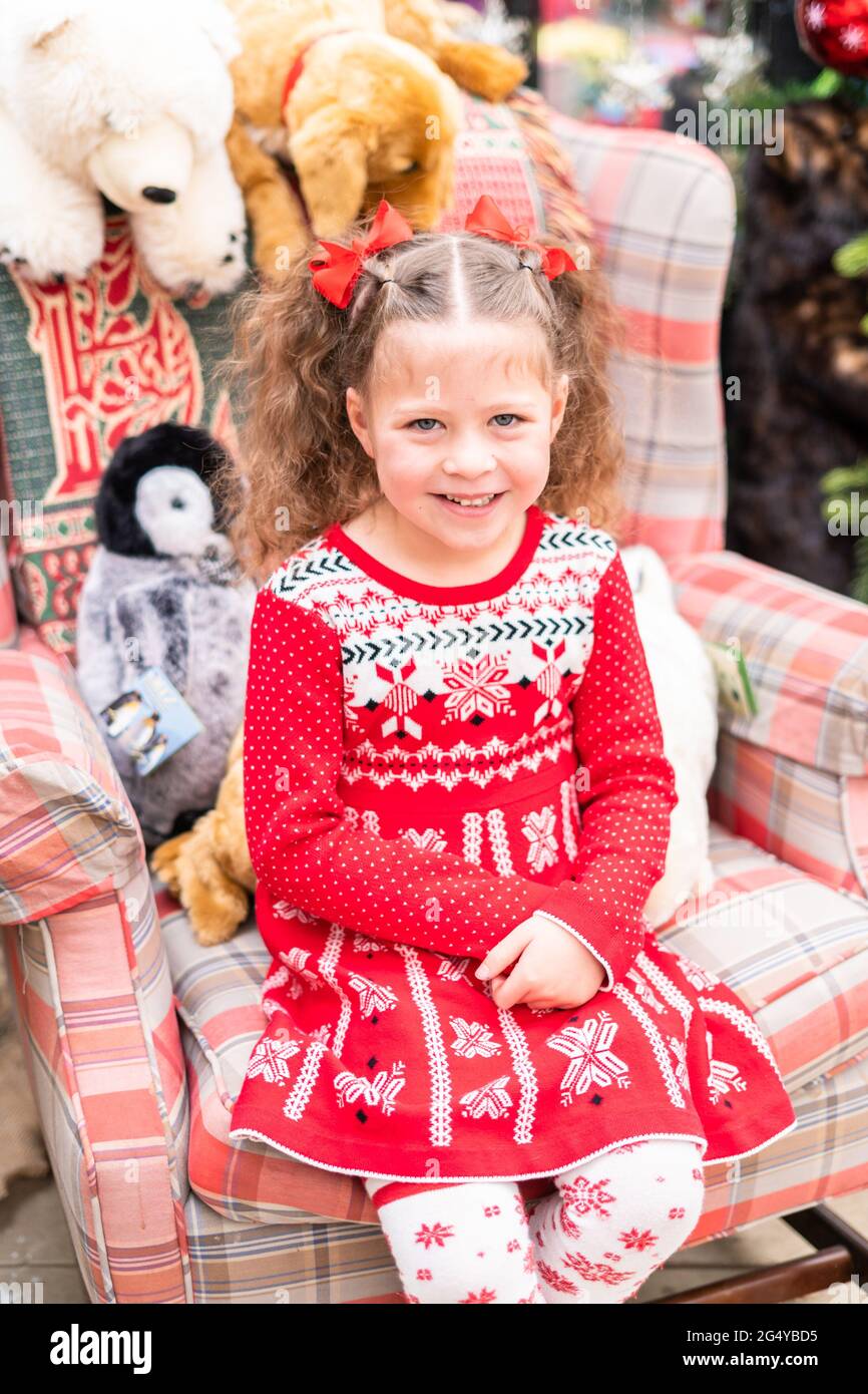 Little girl in red dress at the Christmas tree farm Stock Photo - Alamy