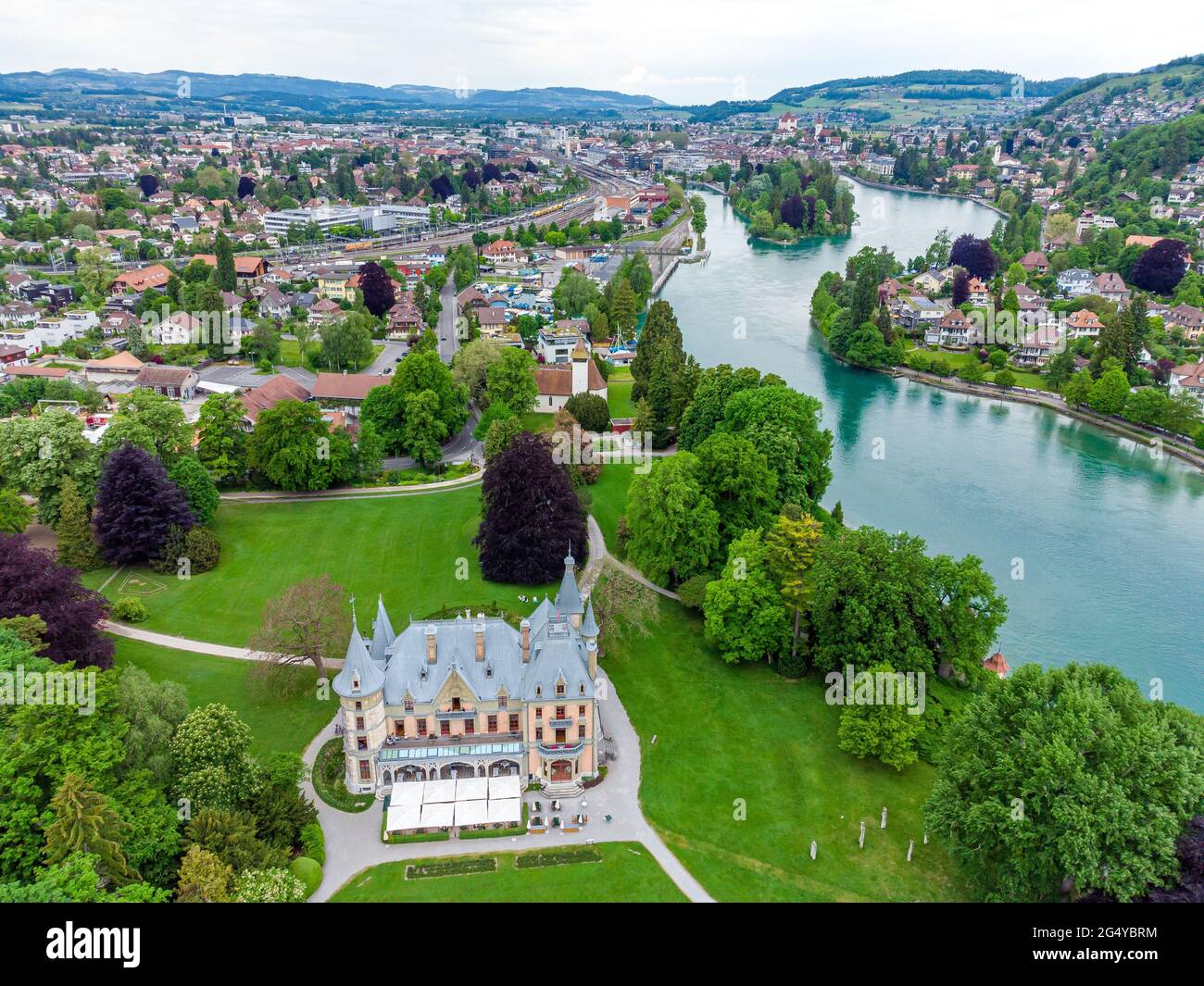 Castle Schadau on Thun Lake (Thunersee, Thuner See), green fields, river Switzerland. Stock Photo