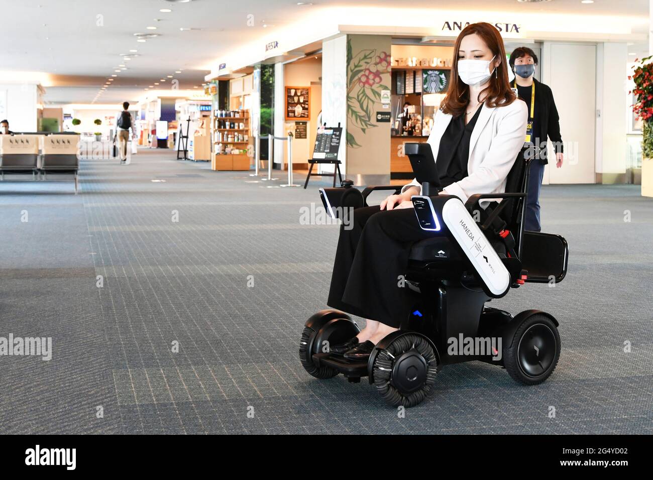 WHILL, an automated electric wheelchair, automatically approaches the boarding gate of Haneda