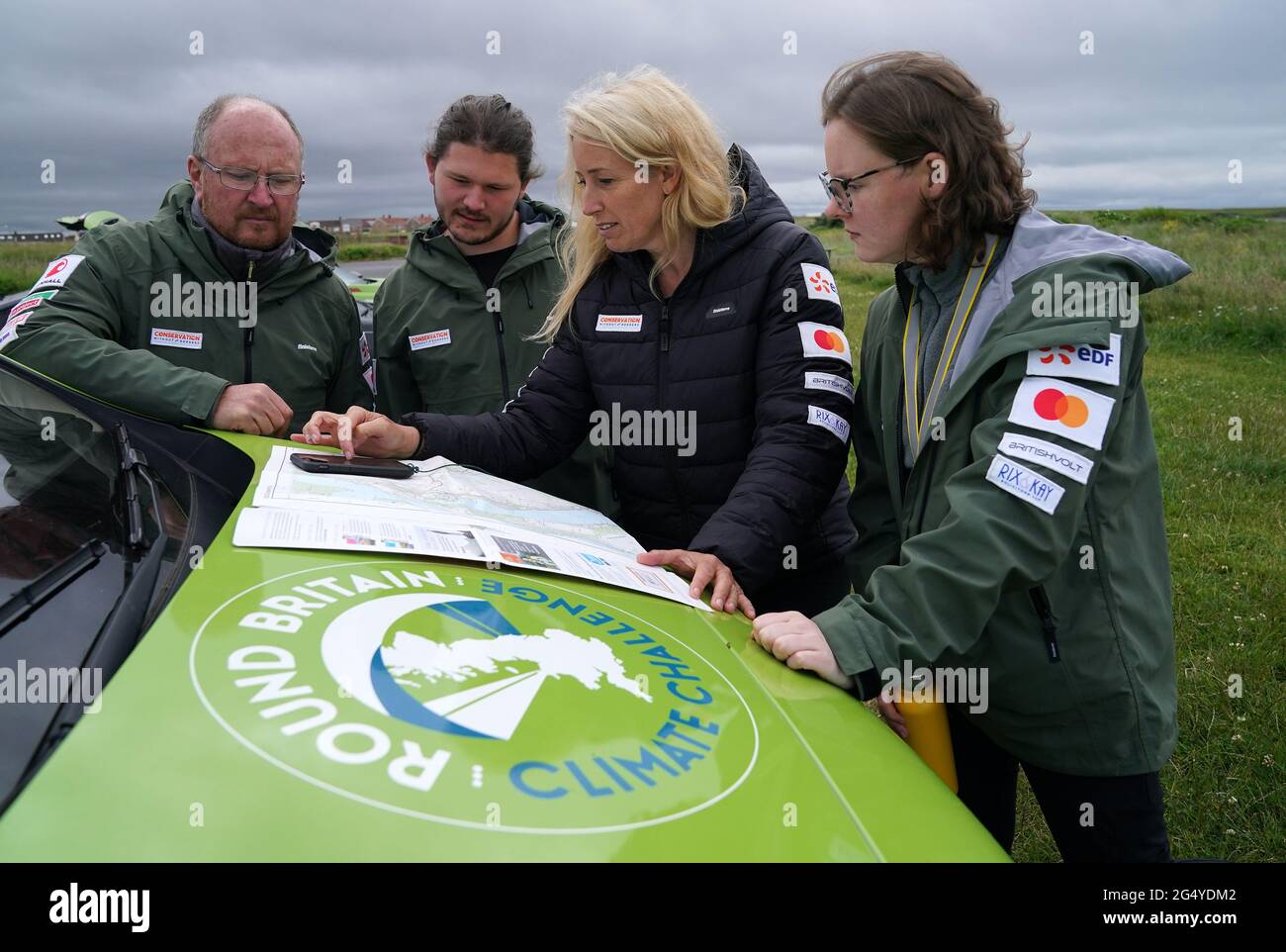 Paramotorist Sacha Dench chats with her team as they check the weather in Stevenston to see if the conditions are right for flight. Picture date: Thursday June 24, 2021. Stock Photo