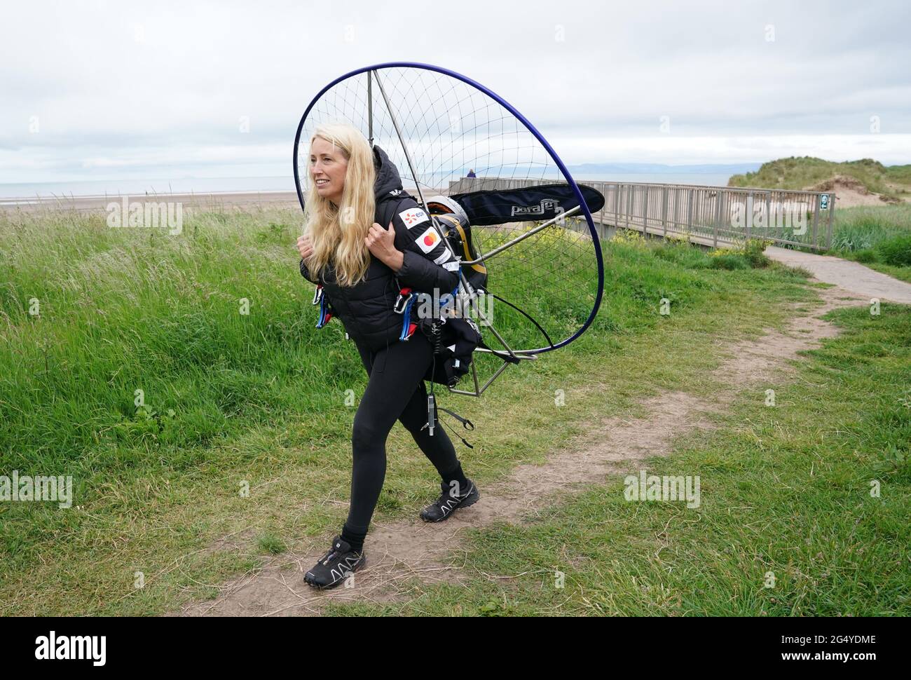 Paramotorist Sacha Dench with her adapted electric paramotor as she checks the weather at Stevenston to see if the conditions are right for flight. Picture date: Thursday June 24, 2021. Stock Photo