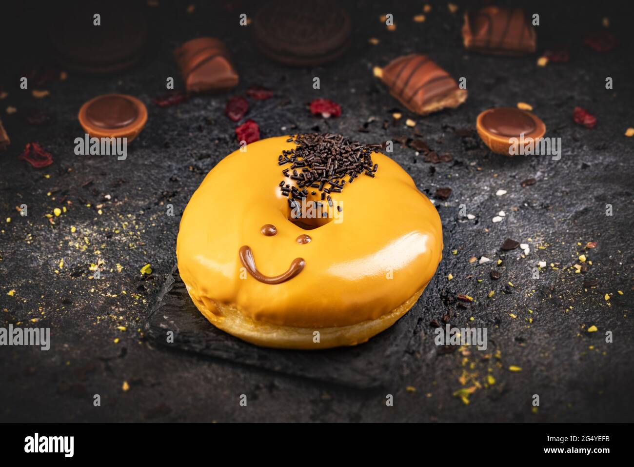 Funny face doughnut or donut on black slate background Stock Photo