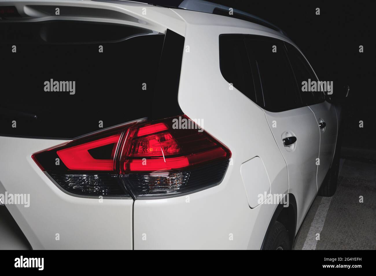 Back of white suv car with red rear lights close up view Stock Photo