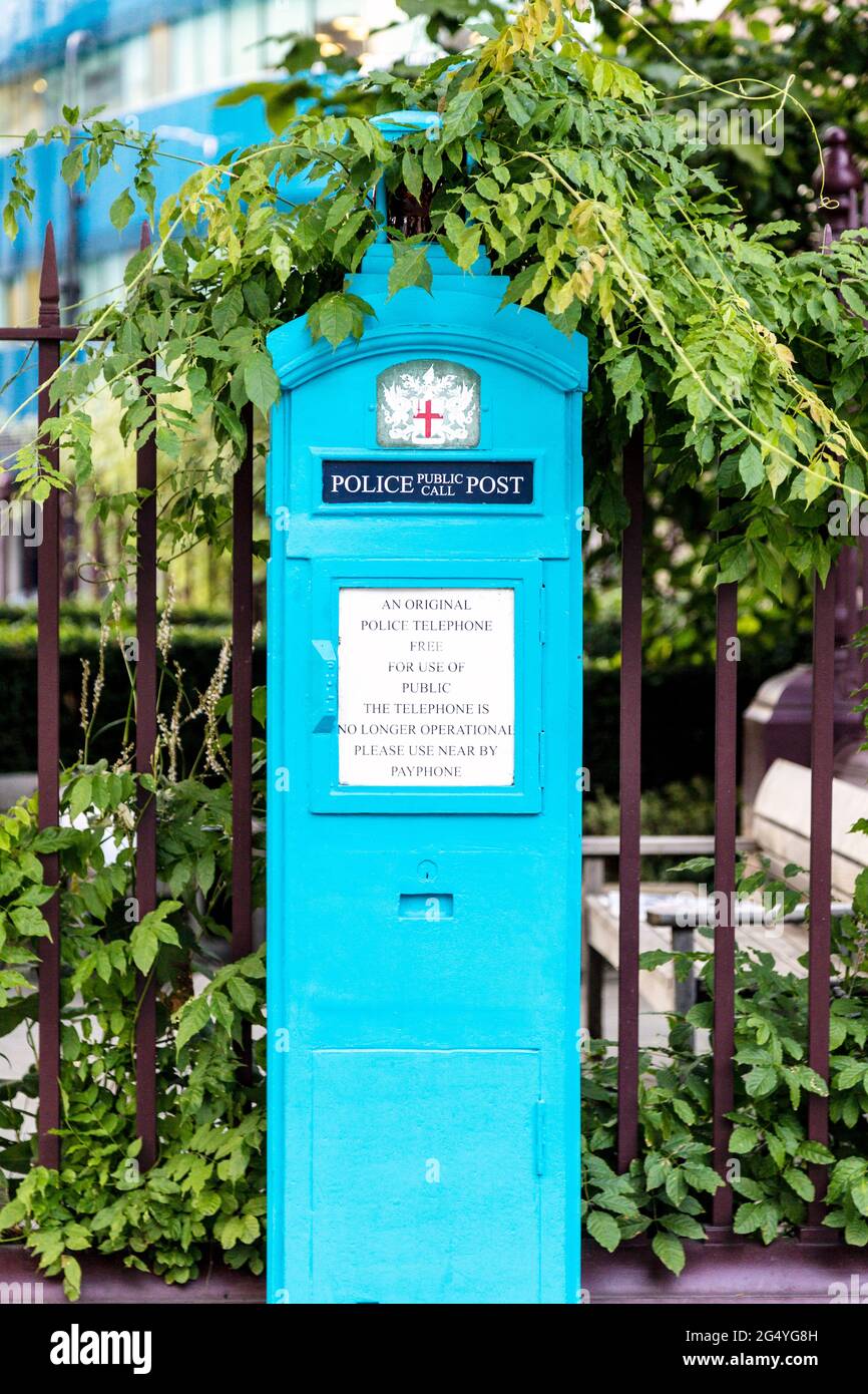 Old, blue Police Box outside St Botolph without Aldgate church in Aldgate, London, UK Stock Photo