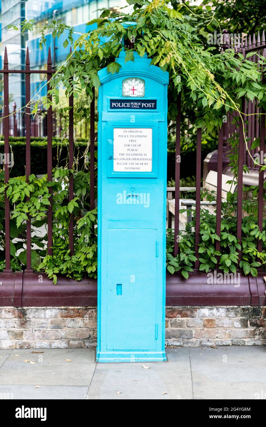 Old, blue Police Box outside St Botolph without Aldgate church in Aldgate, London, UK Stock Photo