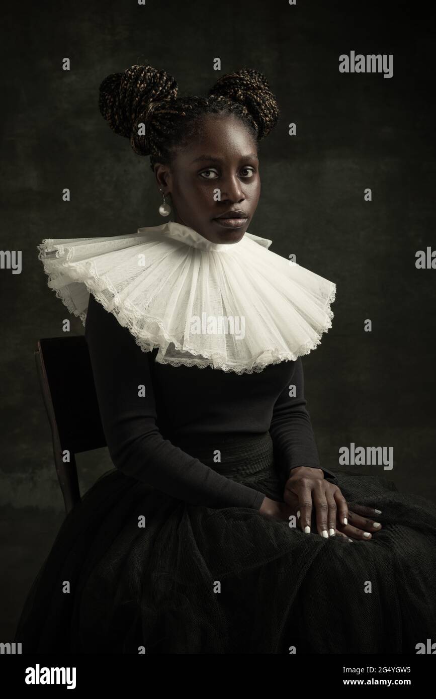 Portrait of medieval African young woman in black vintage dress with ...