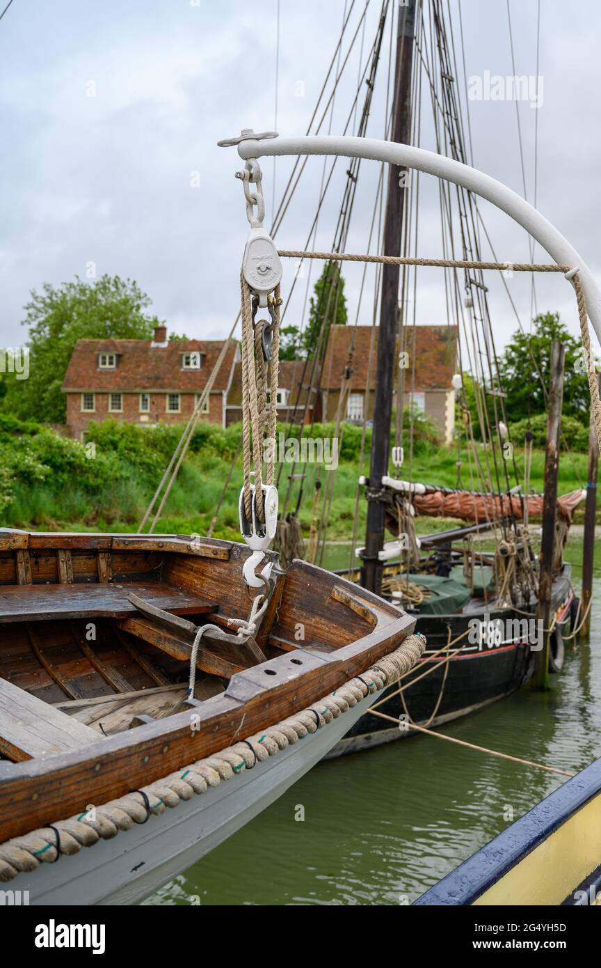 The dinghy of sailing barge 'Edith May' in the foreground with the Whitstable Oyster Smack Thistle F86 behind moored in Lower Halstow, Kent, England. Stock Photo