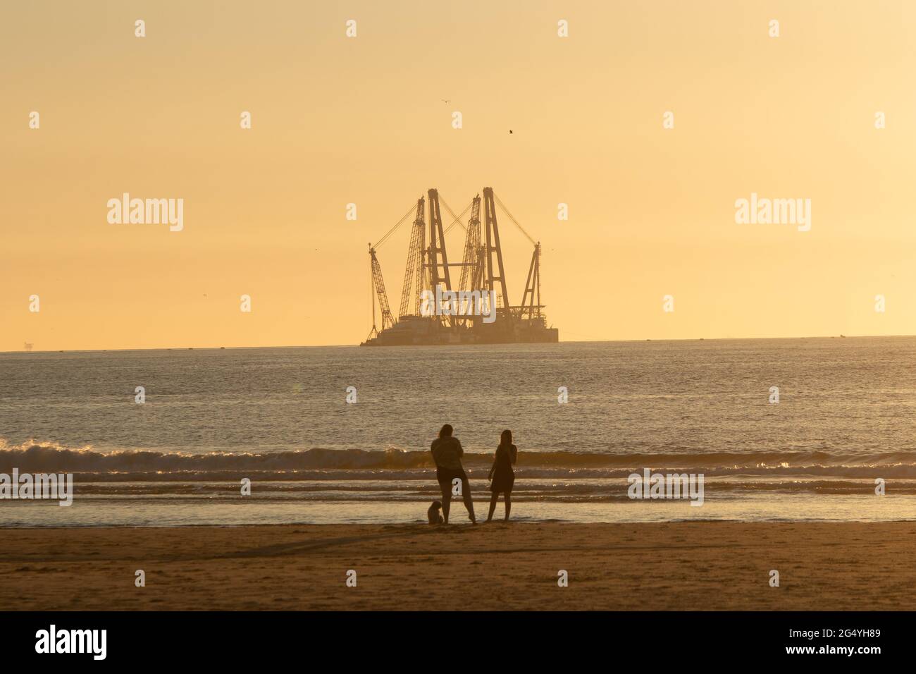 Kijkduin beach, The Hague, The Netherlands - June 13 2021: Heavy industry wind turbine installation barge off the Dutch coast, building an offshore wi Stock Photo
