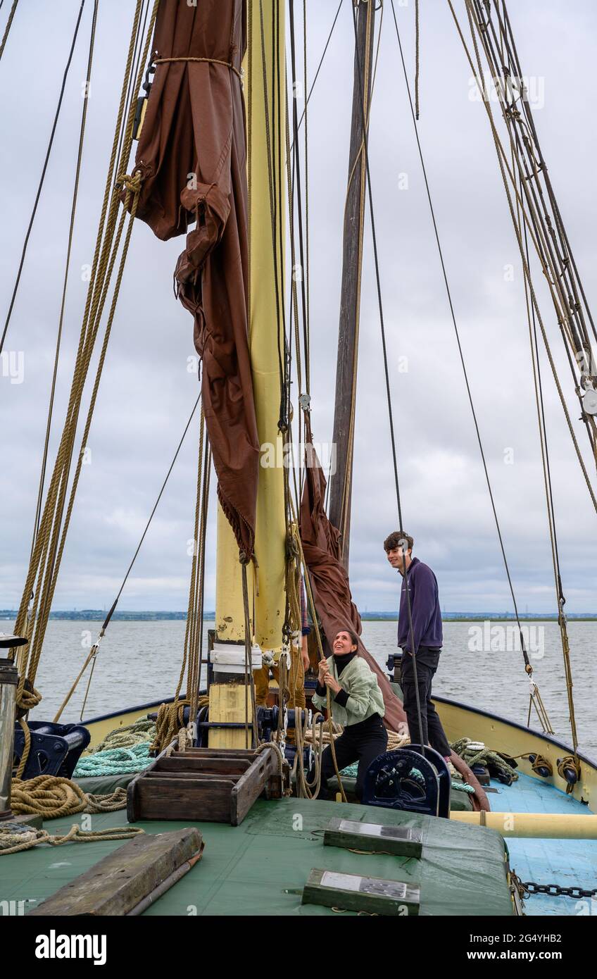 Learning the ropes Two passengers on "Edith May" sailing barge helping