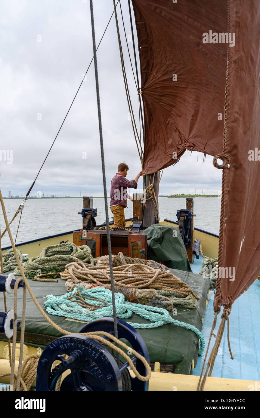 Skipper Ed Gransden rigging the foresail on "Edith May", a historic