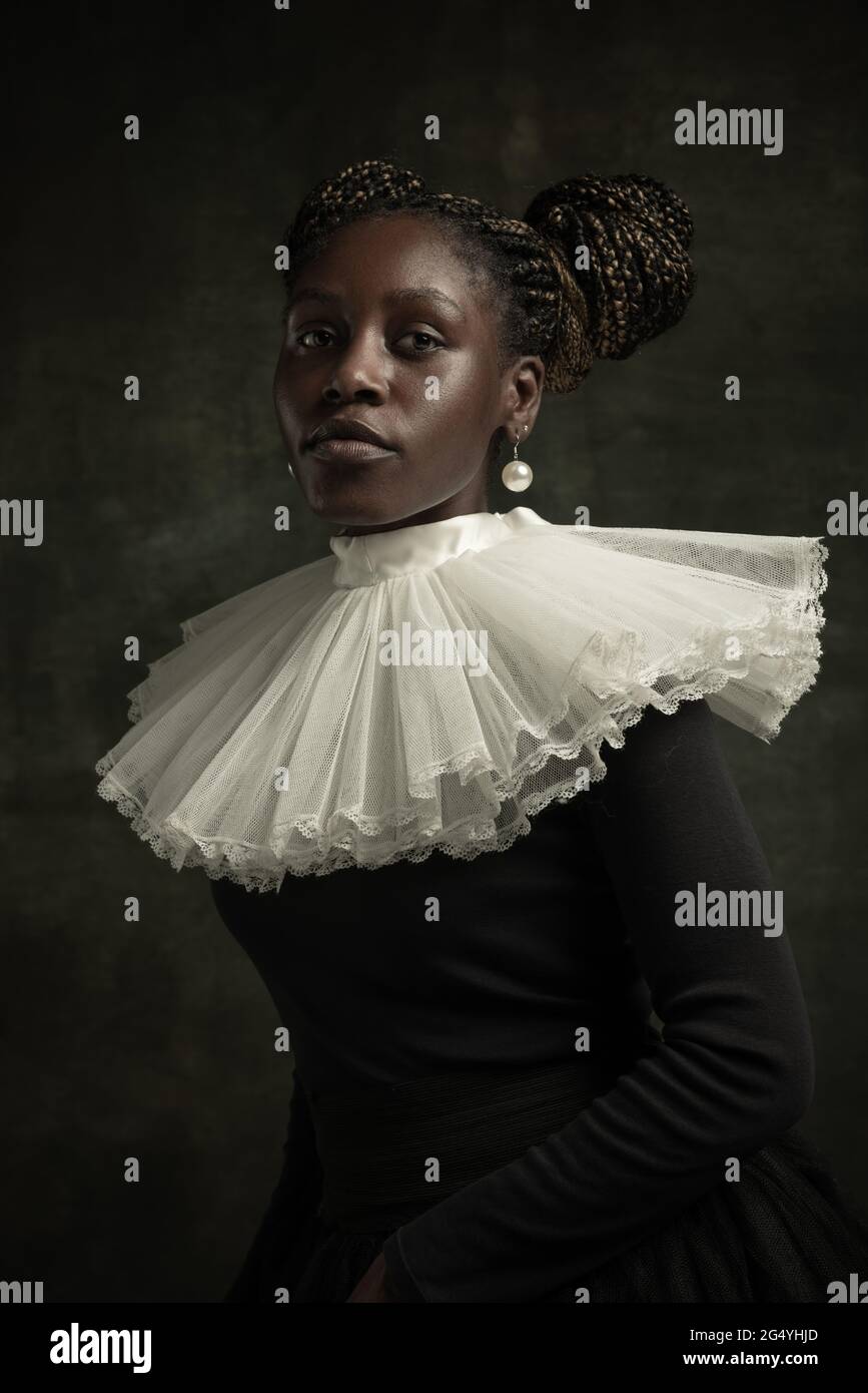 Portrait of medieval African young woman in black vintage dress with ...