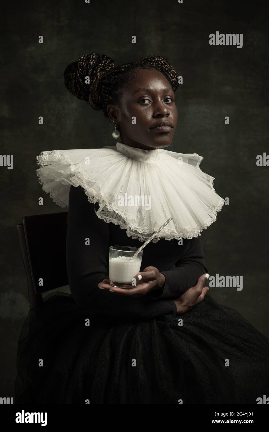 Portrait of medieval African young woman in black vintage dress with ...