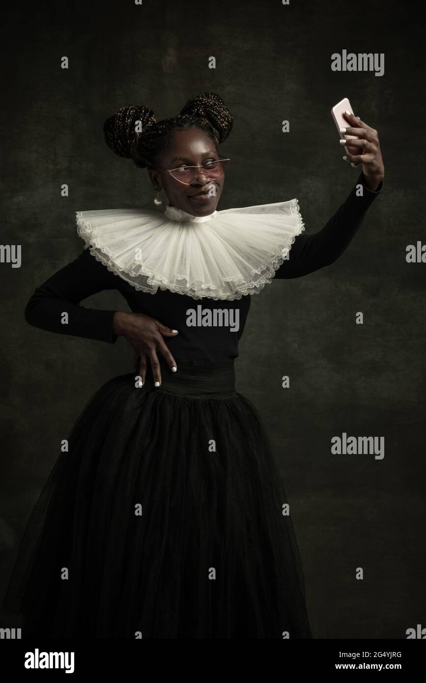 Portrait of medieval African young woman in black vintage dress with ...