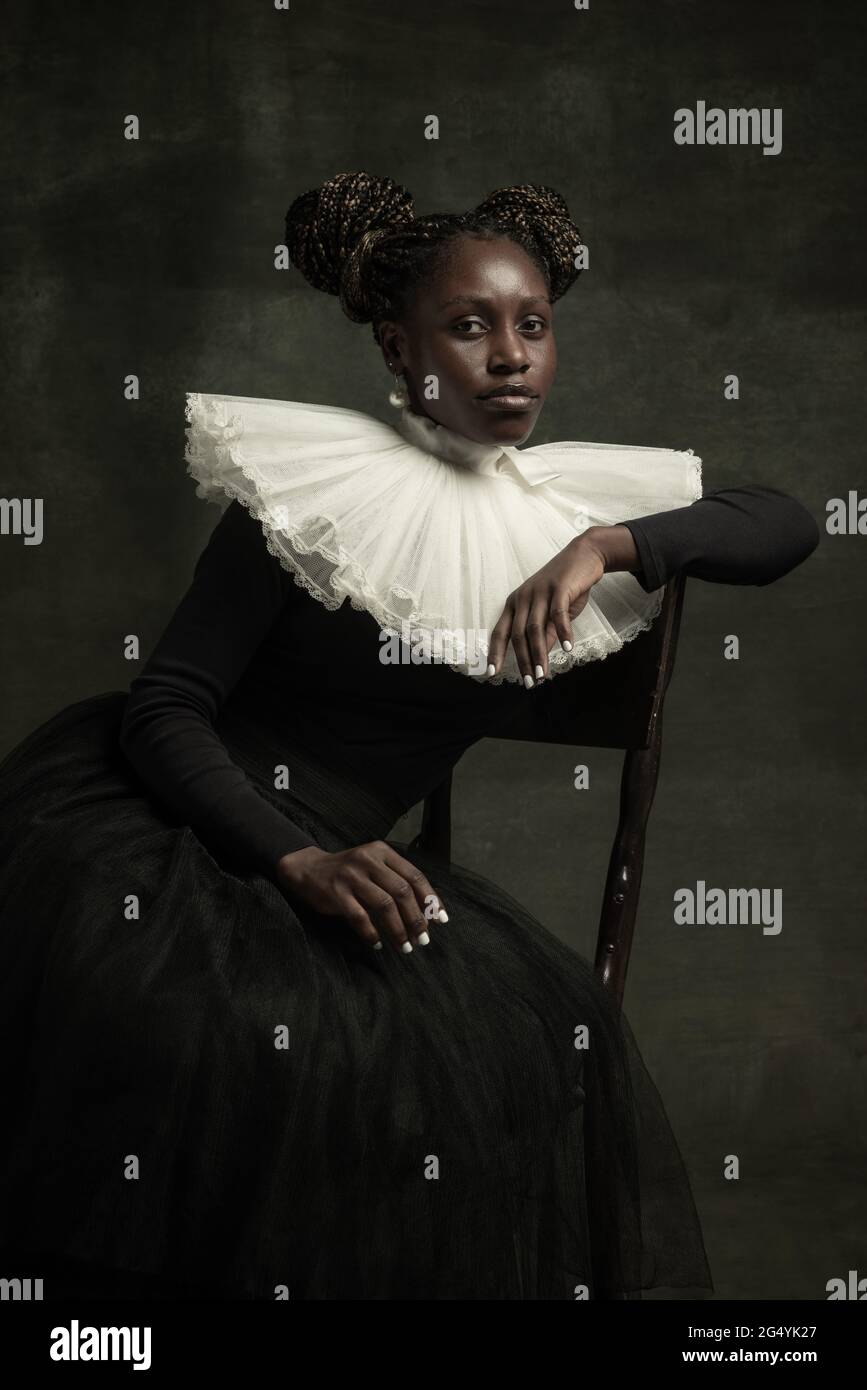 Portrait of medieval African young woman in black vintage dress with ...