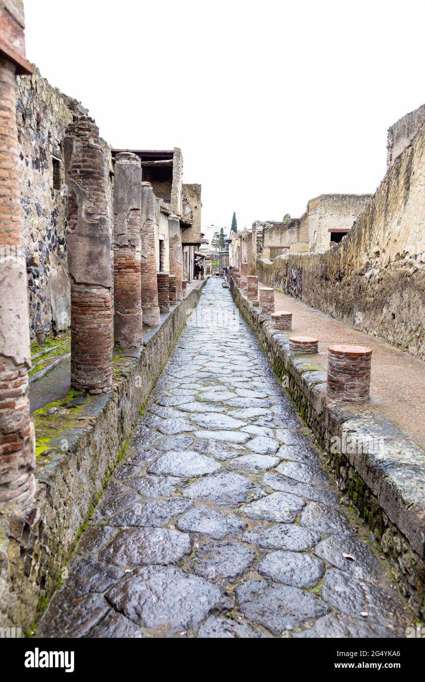 Street with runis of pillars at the archeological site of the Ancient City of Herculaneum, Campania, Italy Stock Photo