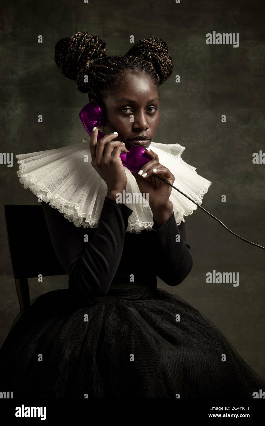 Portrait of medieval African young woman in black vintage dress with ...