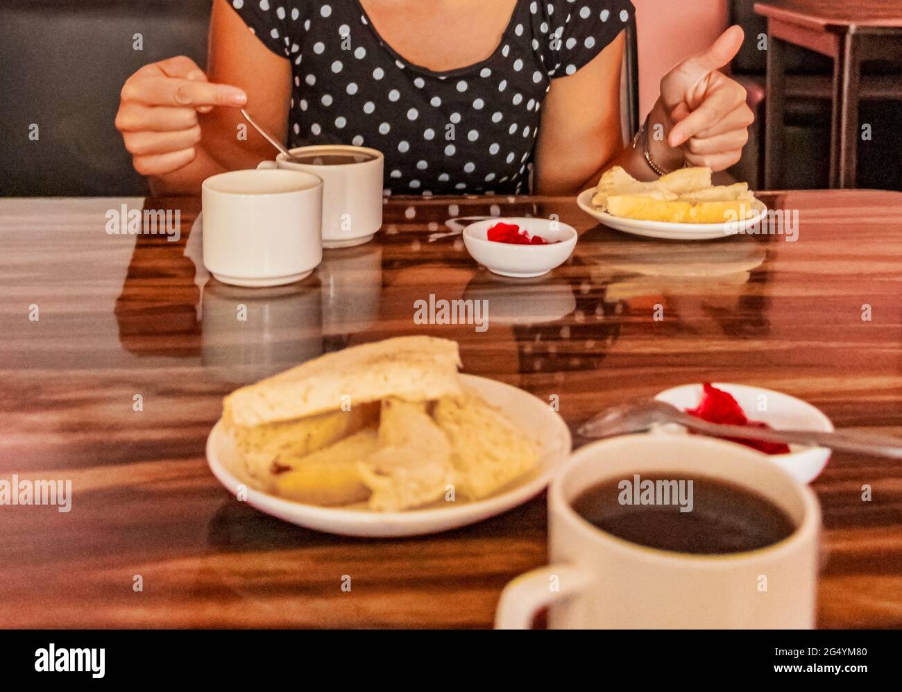 Simple hotel hostel breakfast with toast jam butter and black coffee on