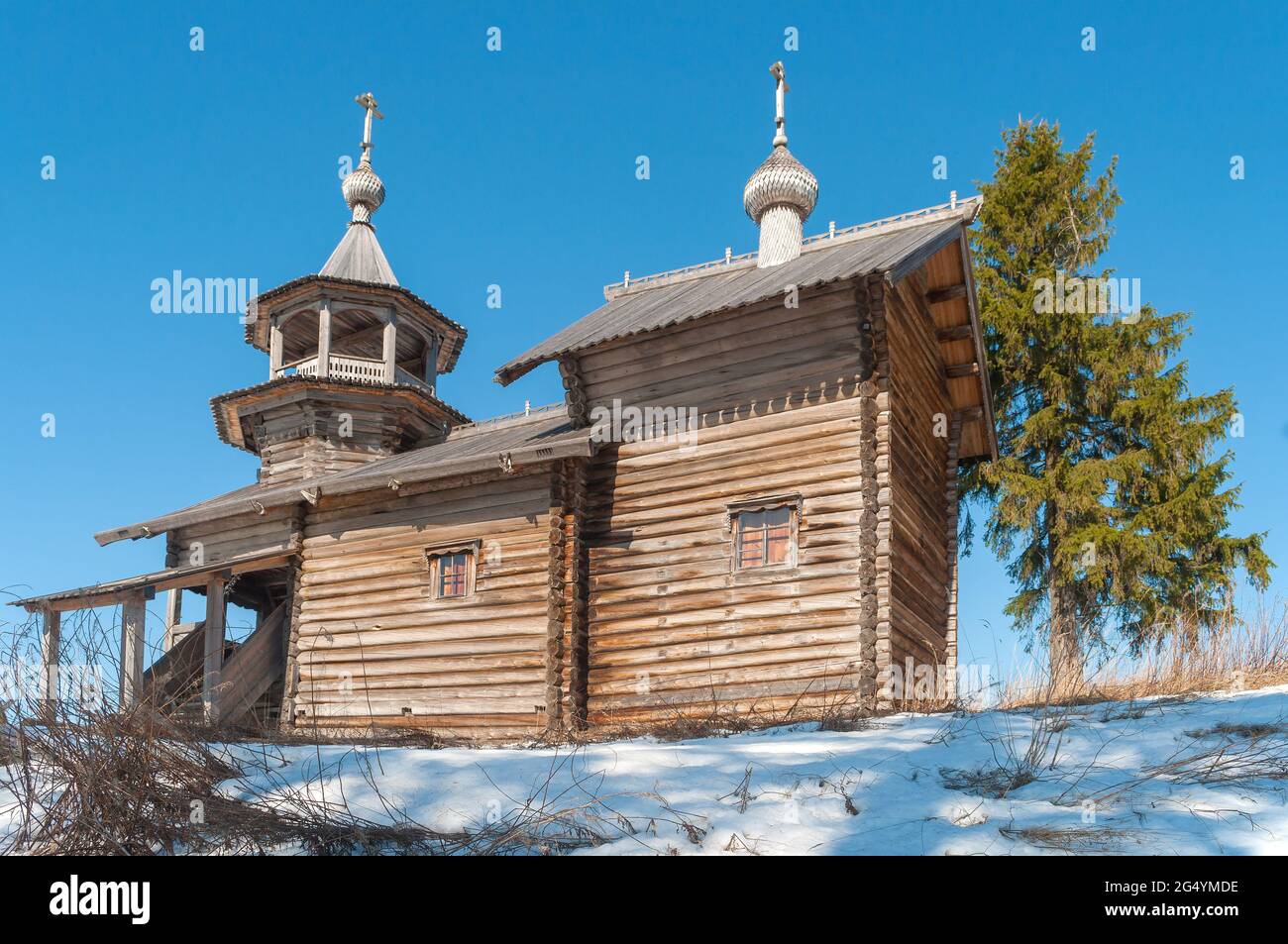 Old wooden chapel of the Nativity of the Virgin close up on a sunny April day. Manga village, Karelia. Russia Stock Photo