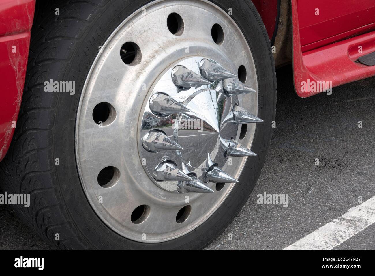 A red Ford truck with chrome spiked axle covers. In Queens, New York. Stock Photo