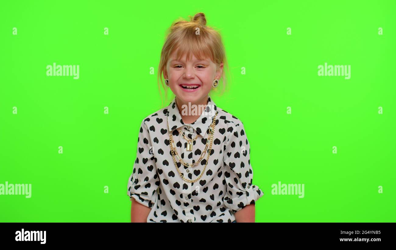 Smiling kid child laughing out loud after hearing ridiculous anecdote, funny joke, carefree amused Stock Photo