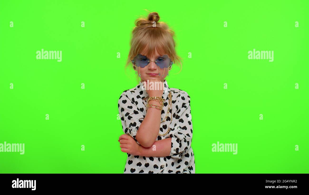 Playful happy kid girl in sunglasses blinking eye, looking at camera