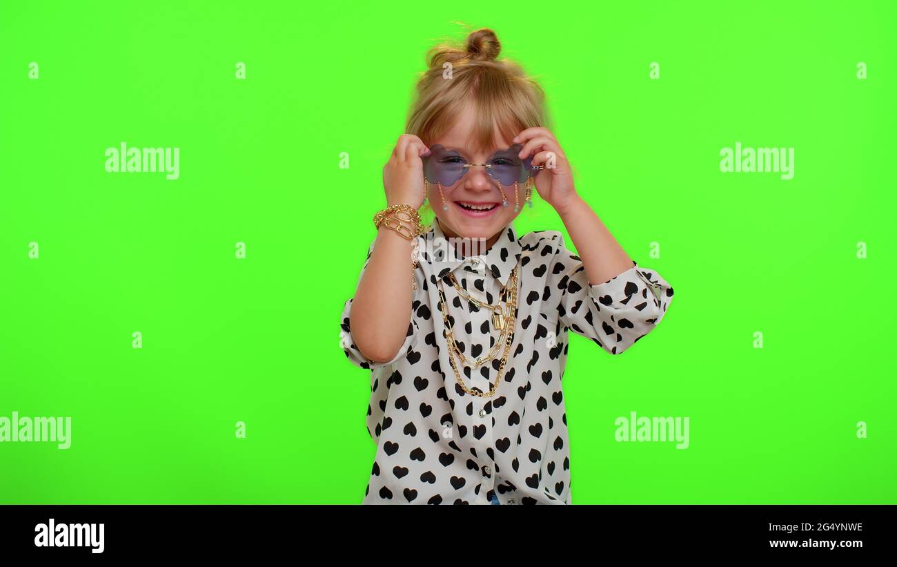 Playful happy kid girl in sunglasses blinking eye, looking at camera