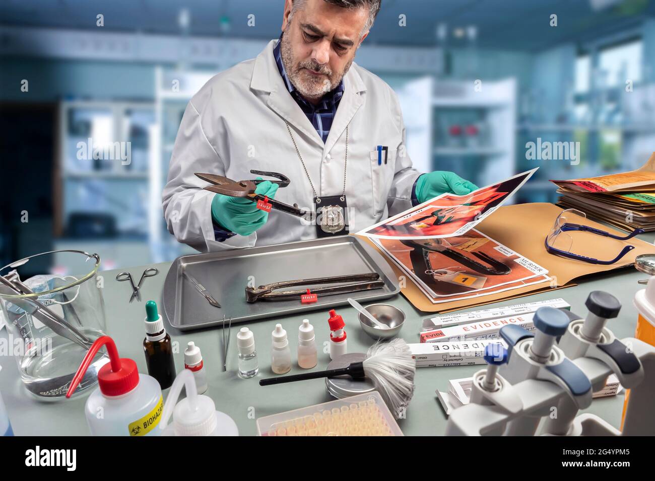 Police scientist extracts DNA sample from a pair of pliers in a crime lab, concept image Stock Photo