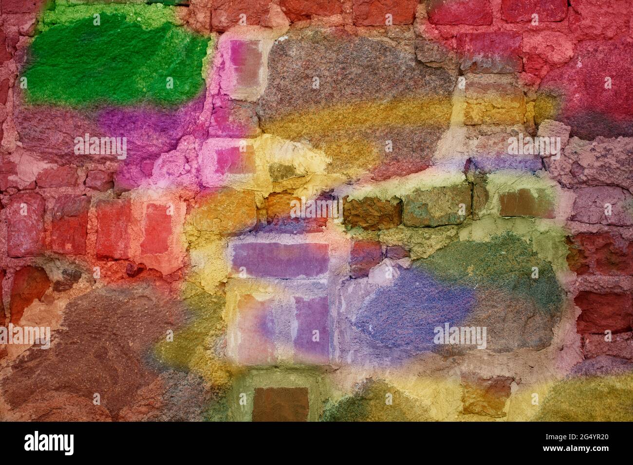 Brick wall with multi-colored paint close-up. Background brick creative. Stock Photo