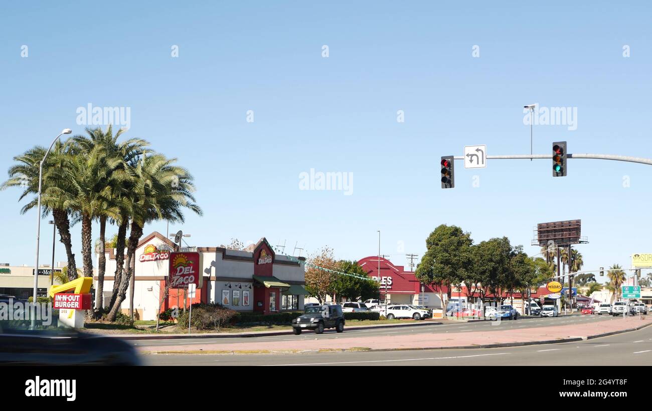 San Diego, California USA - 29 Nov 2020: Fast food restaurants on city street. In-n-out Burger drive thru, Del Taco logo, marketing advertising signs Stock Photo