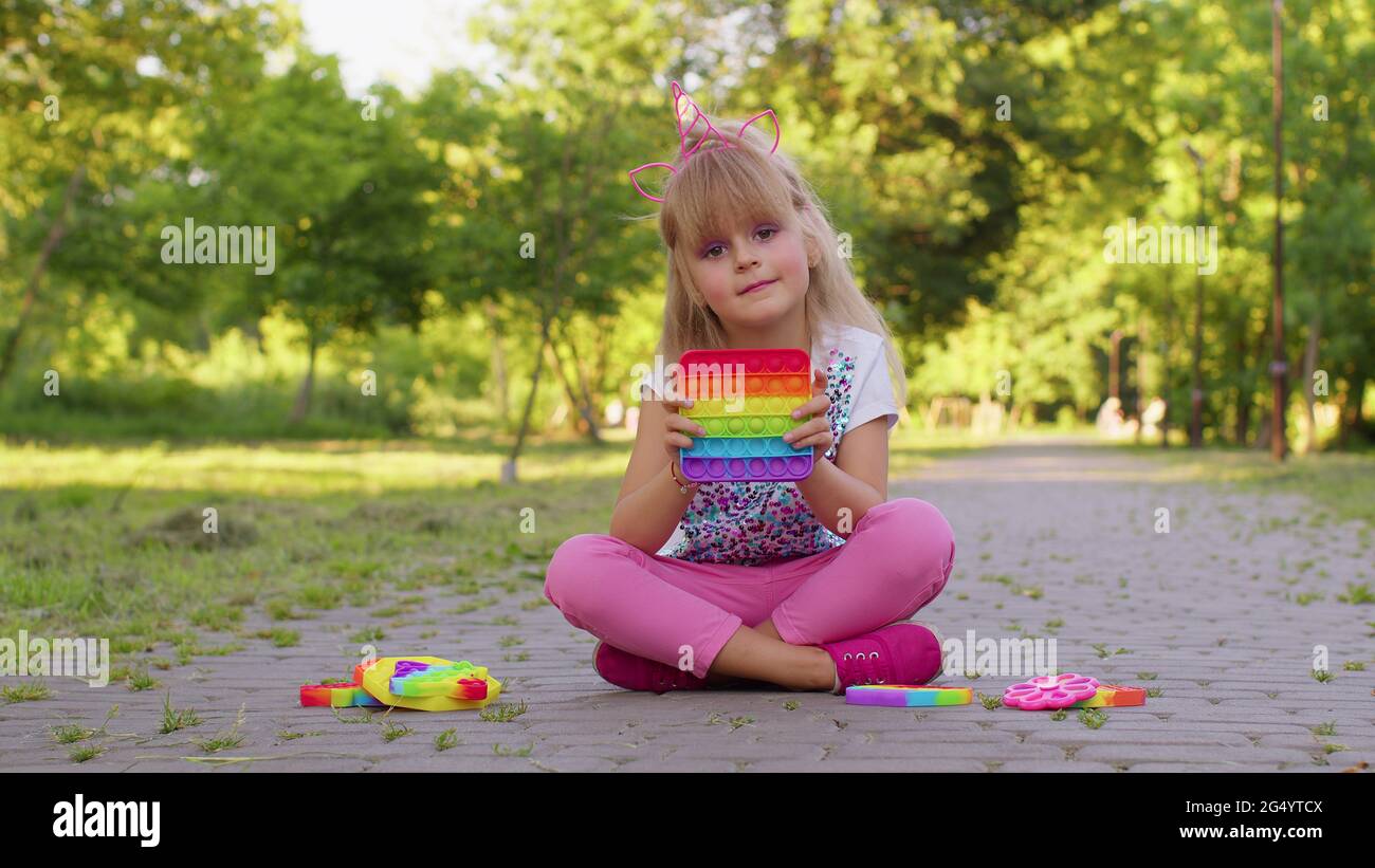 Child girl kid playing push pop it bubble squeeze fidget sensory toys