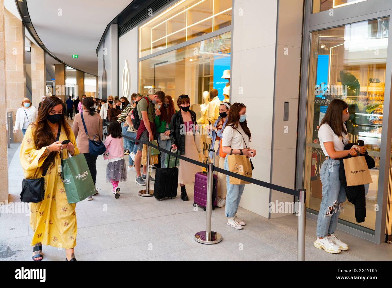 Edinburgh, Scotland, UK. 24 June 2021. First images of the new St James Quarter which opened this morning in Edinburgh. The large retail and residential complex replaced the St James Centre which occupied the site for many years. Pic； Long queue of shoppers outside Stradivarius shop. Iain Masterton/Alamy Live News Stock Photo