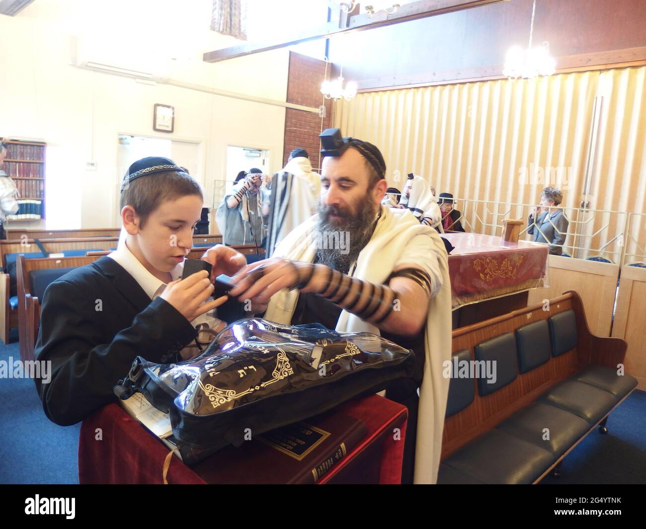 A small Jewish community meet for the Hanochas Tefillin celebration of