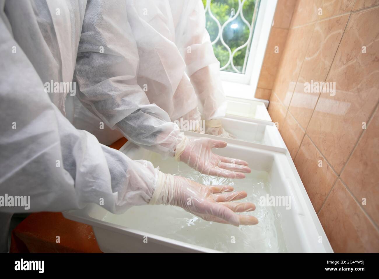 Hand cleaning with disinfectant solution in the hospital gateway during