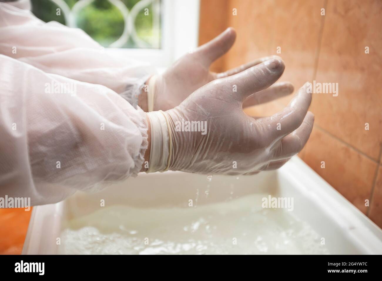Hand cleaning with disinfectant solution in the hospital gateway during