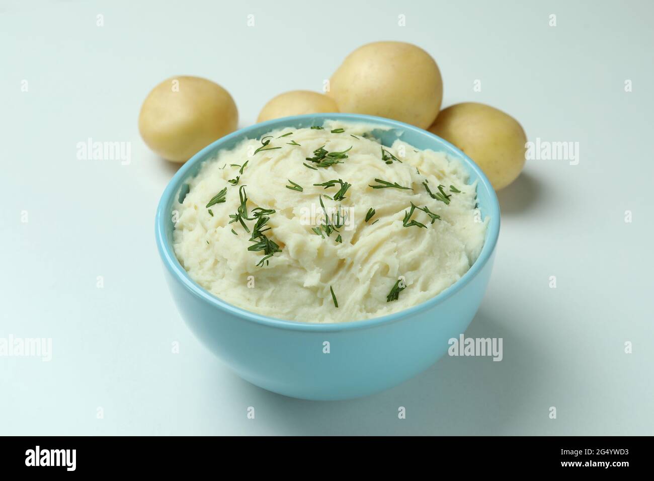 Plate of mashed potatoes and ingredients on white background Stock Photo