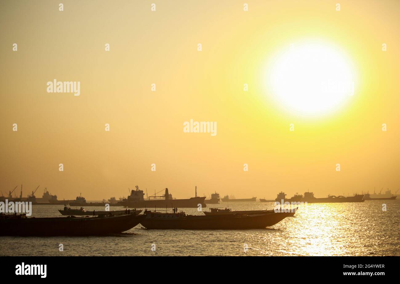 The sea water is glistening in the sunlight.  Chittagong seaport in place Stock Photo