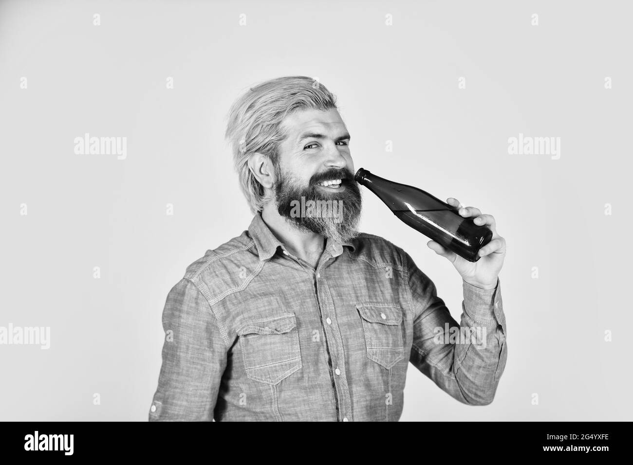 heart of Best Taste. healthy water in glass bottle. brutal hipster drinking alcohol beverage. beer and football. relax after work day. lets have fun Stock Photo