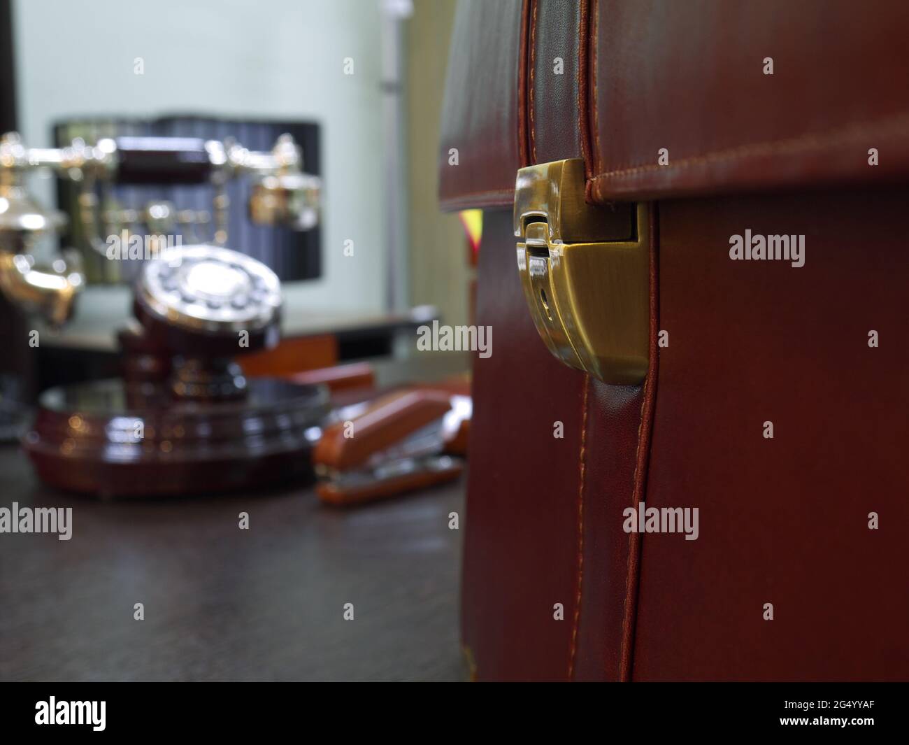 leather briefcase on desktop, closeup, shallow depth of field Stock