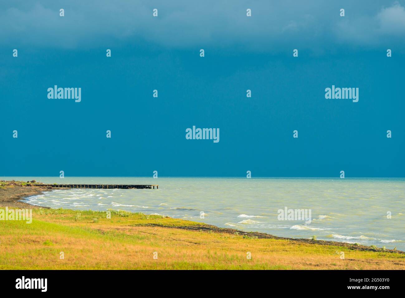 sea and blue dramatic sky. tide at sea during blue twilight in cloudy ...