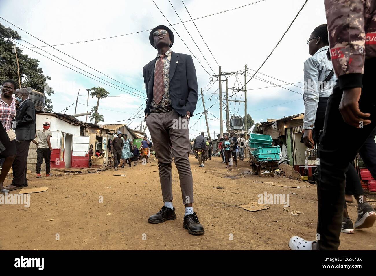 21-year-old Jactone Omondi, a professional electrician and a model poses by  the streets dressed in his Vintage outfits in Kibera. Modern fashion is now  becoming a new trend practiced by different individuals