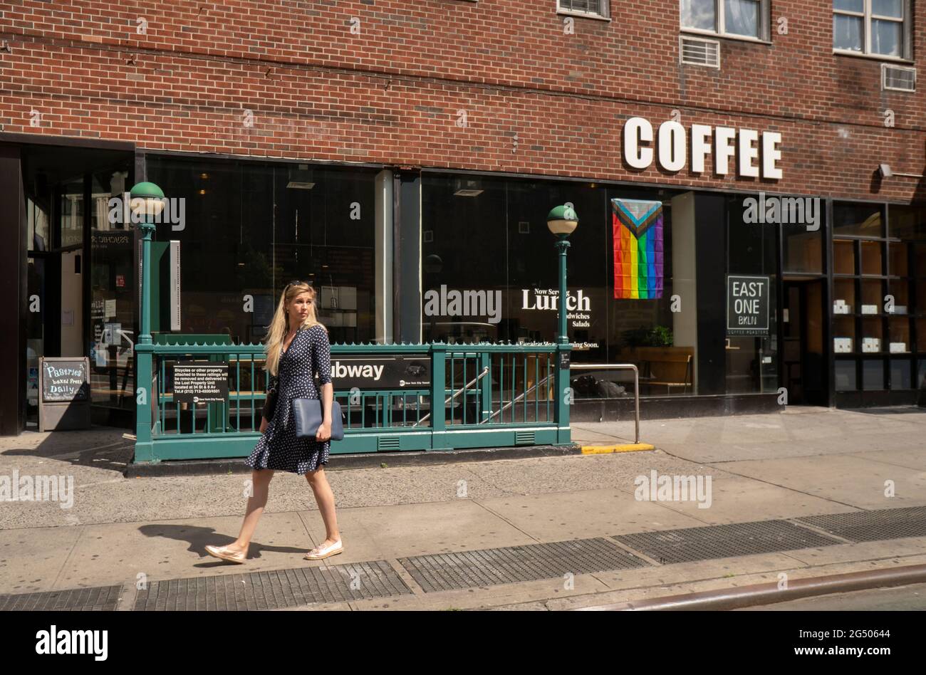 New York, USA. 23rd June, 2021. A coffee shop in the Chelsea neighborhood of New York displays a Progress Pride flag for Gay Pride on Wednesday, June 23, 2021. (ÂPhoto by Richard B. Levine) Credit: Sipa USA/Alamy Live News Stock Photo
