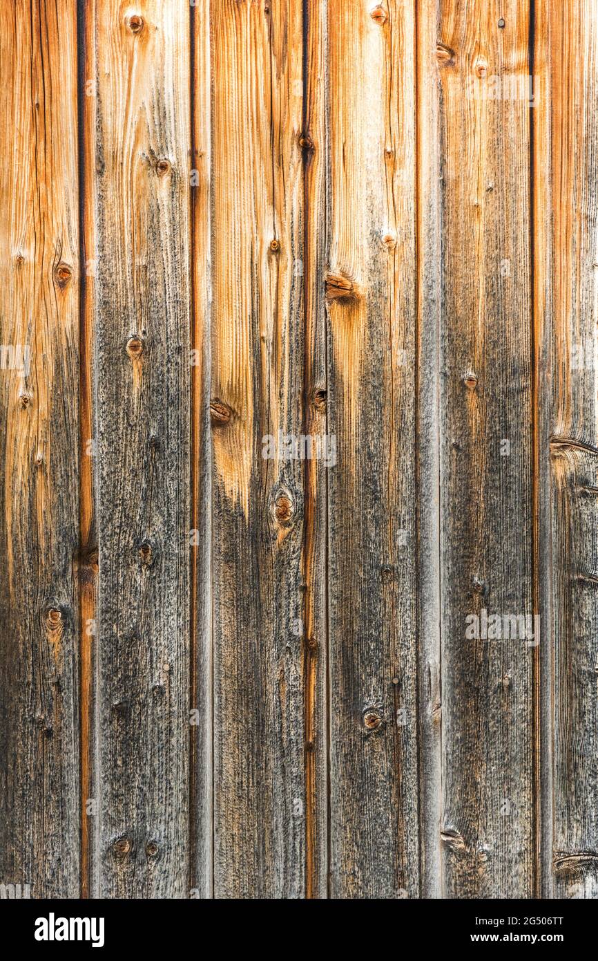 Closeup shot of brown, weathered wooden wall (background vertical) Stock Photo