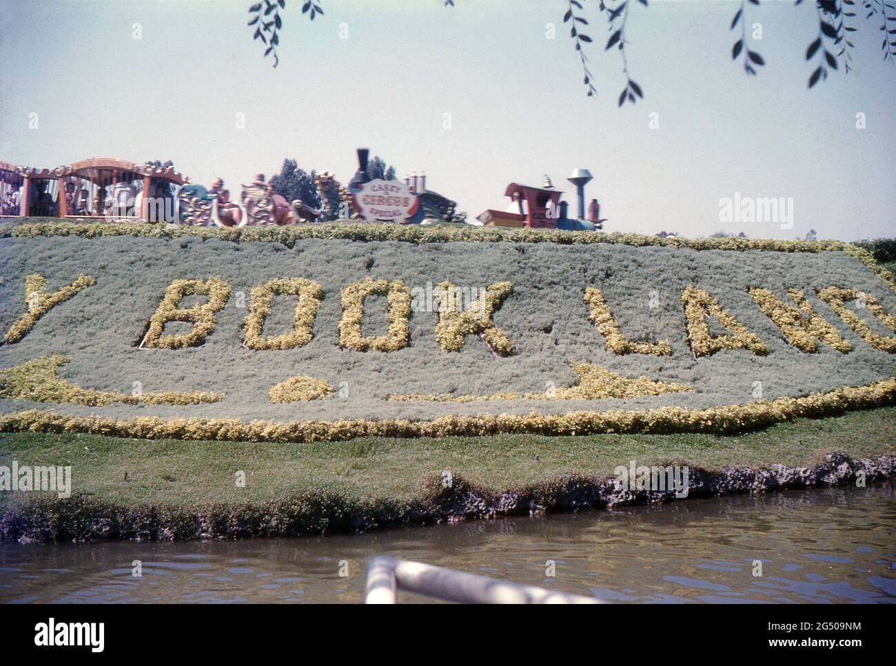 Disneyland, California, 1959. A view of the Casey Jr. Circus Train passing the Storybook Land mural and canal. Stock Photo