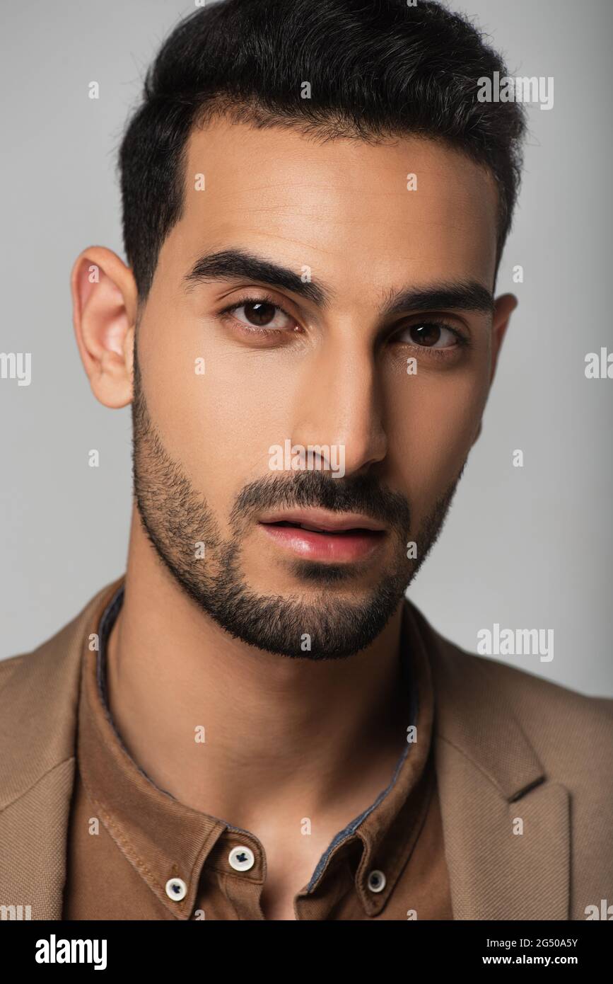 Portrait of muslim businessman isolated on grey Stock Photo - Alamy
